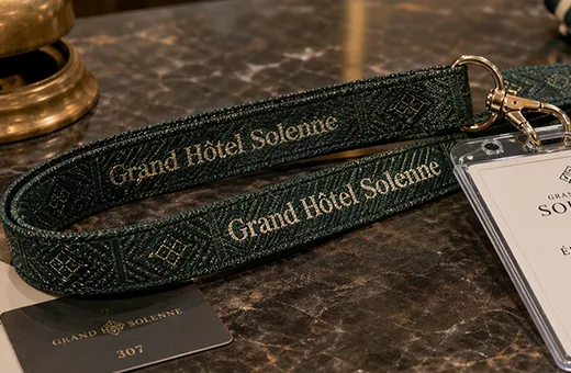 Woven jacquard lanyard with brand name textured into fabric