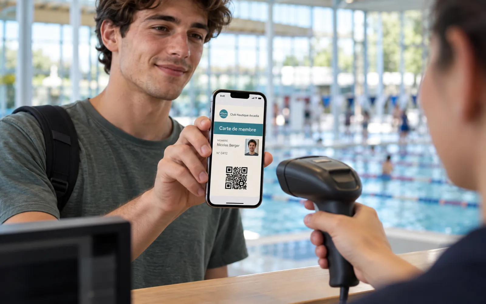 Membership card with photo shown on an iPhone and read by a handheld scanner at reception
